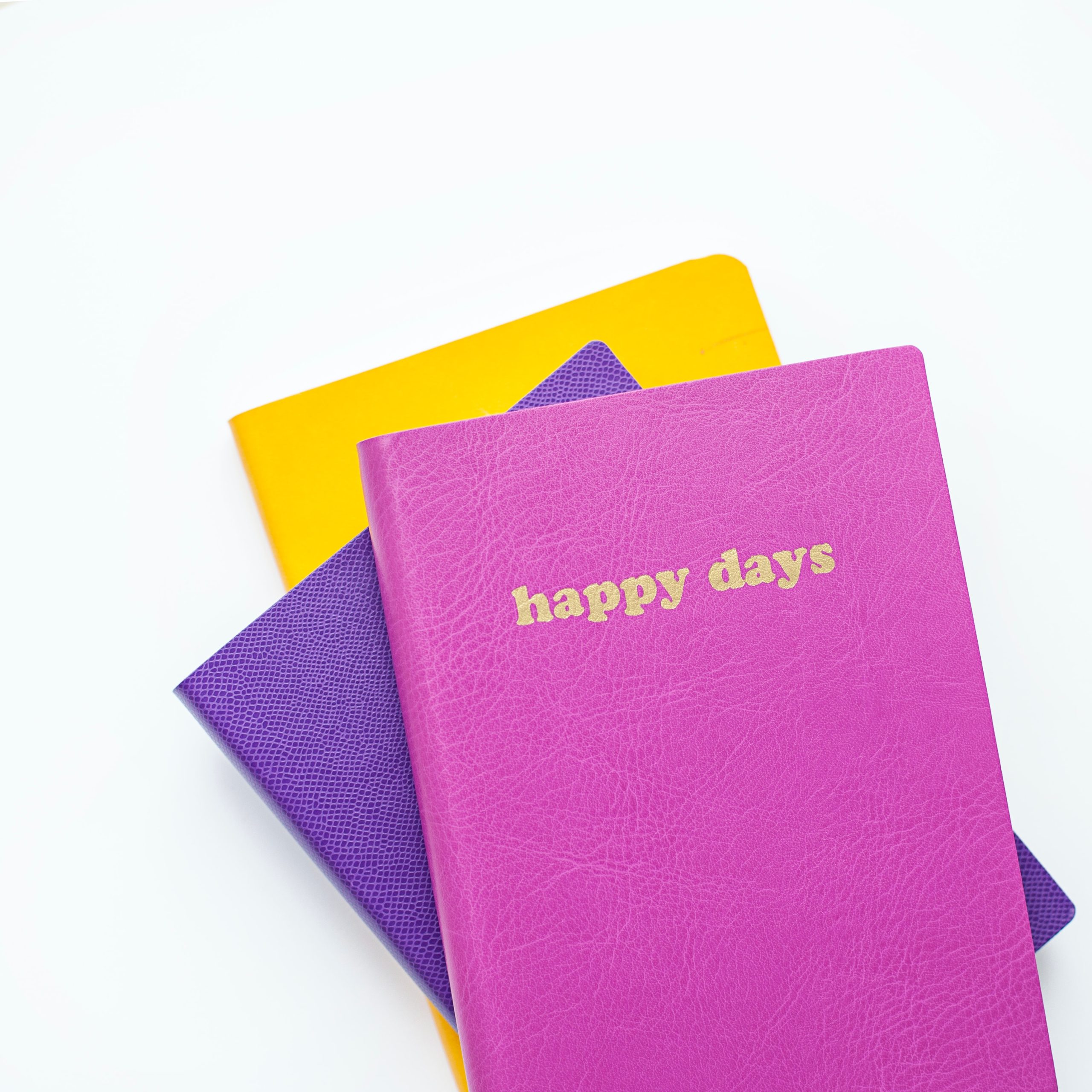 Journal that says "happy days" on the cover