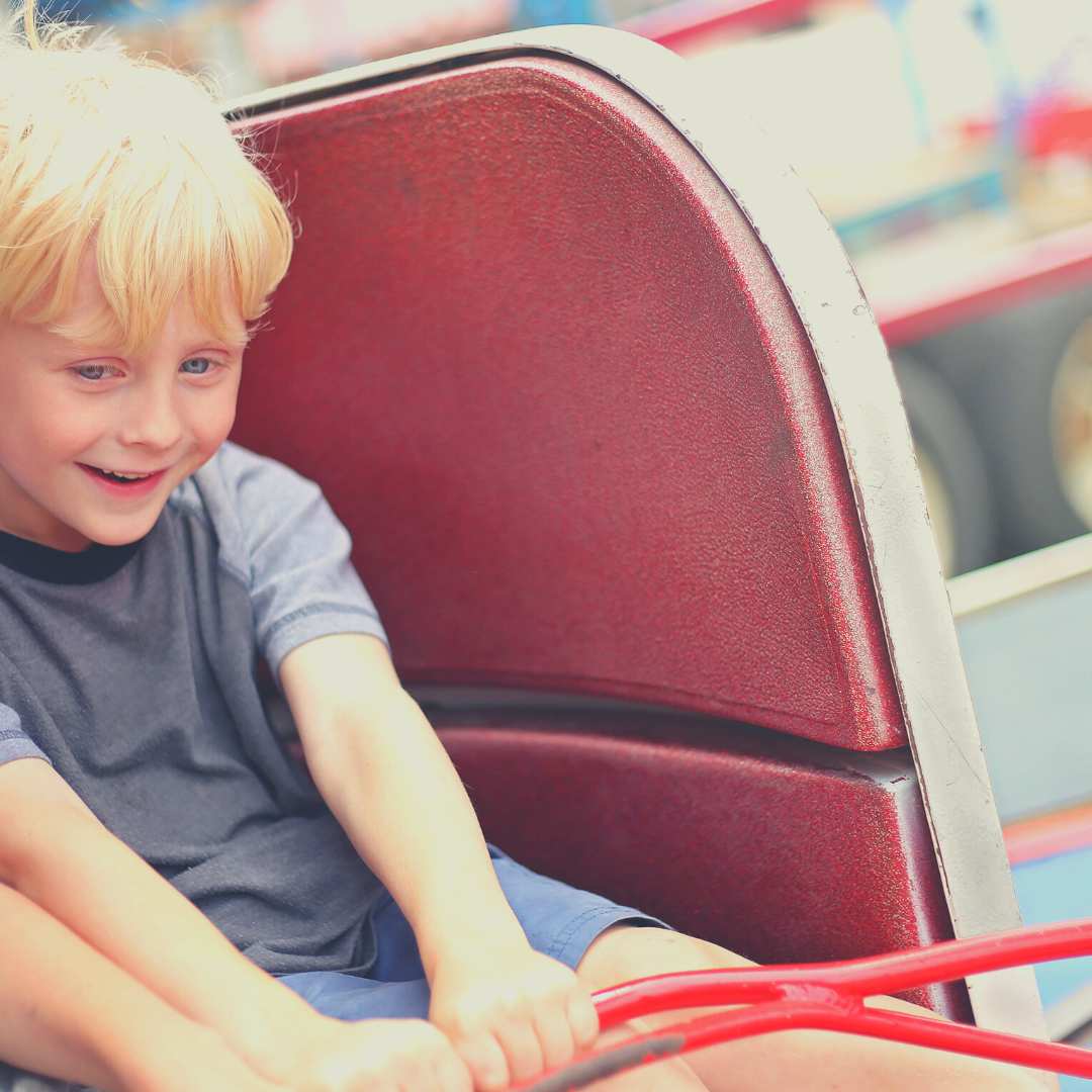 boy on amusement park ride